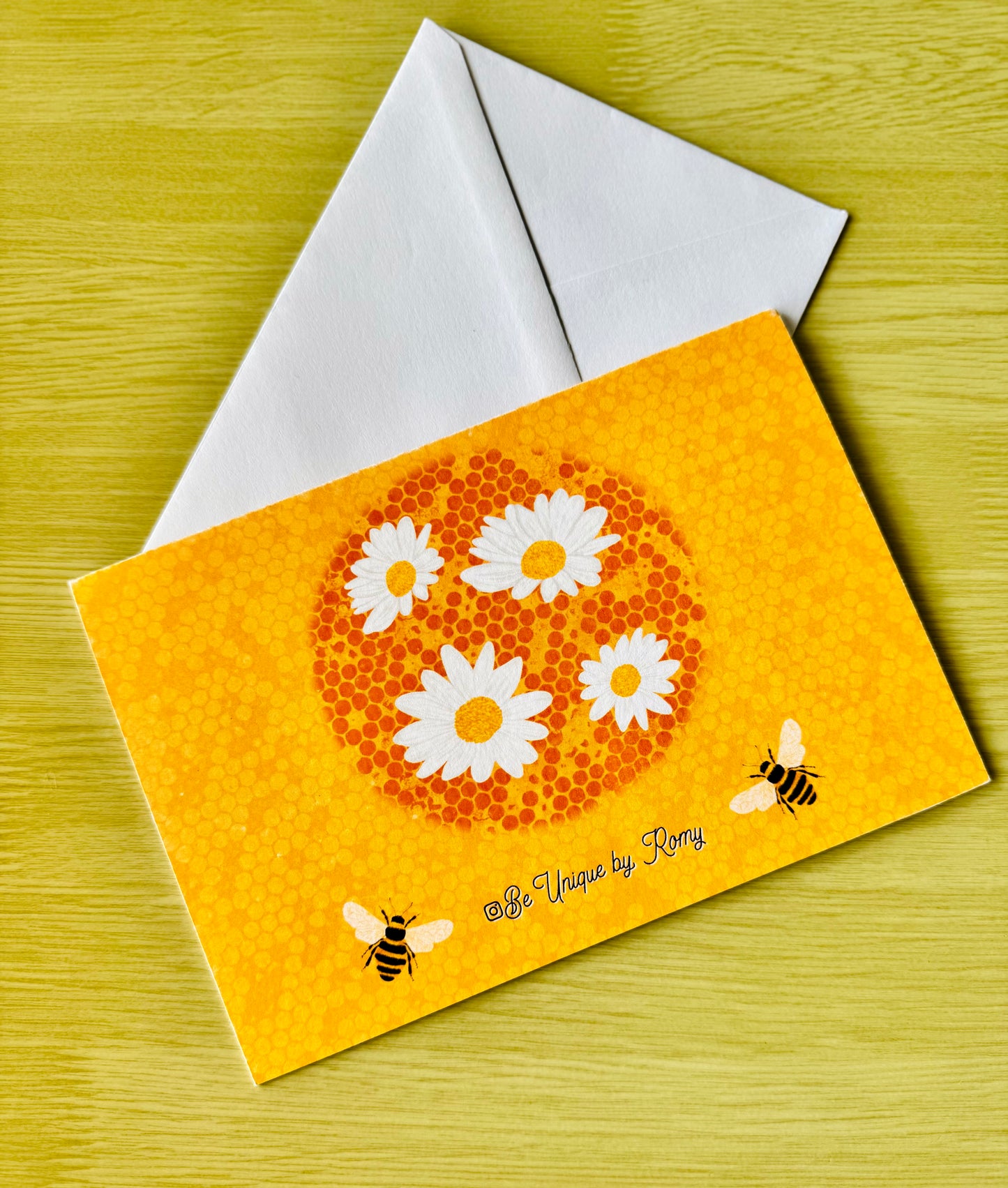 Greeting card with floral design and bee illustrations on a yellow background