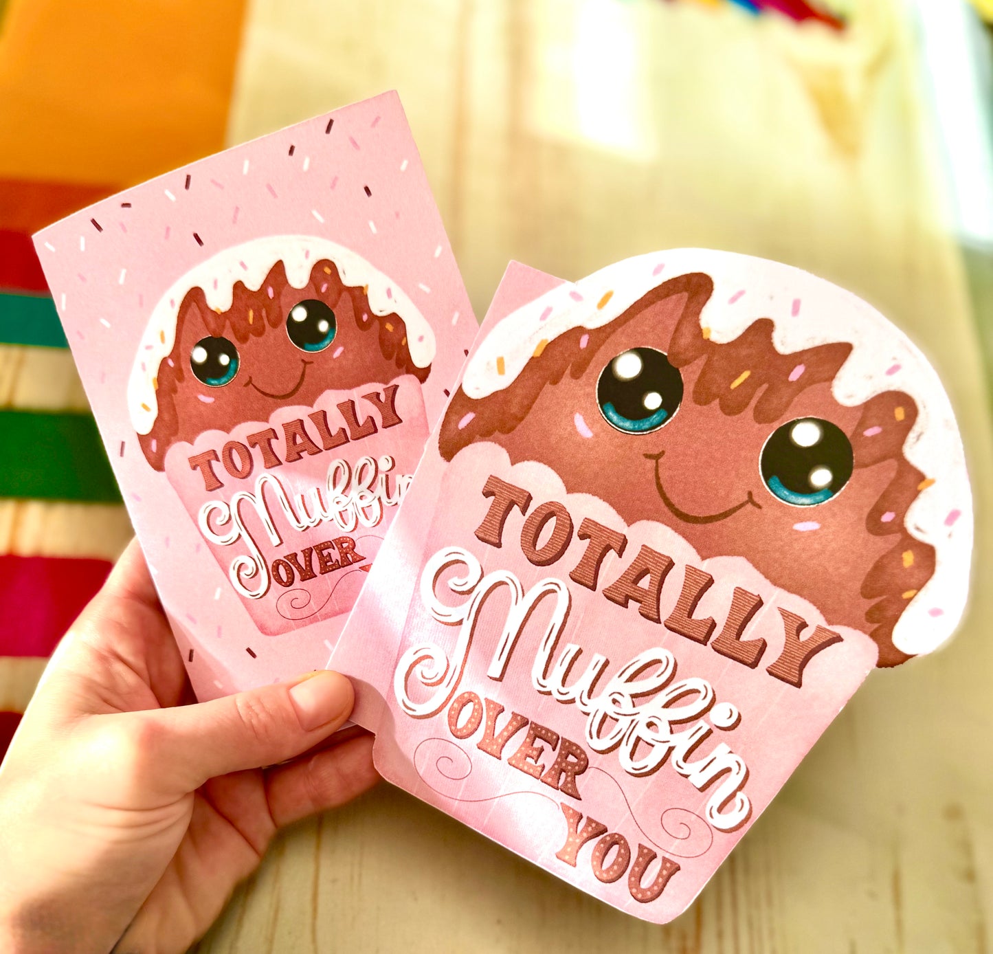 small and muffin shape card holding in hand
